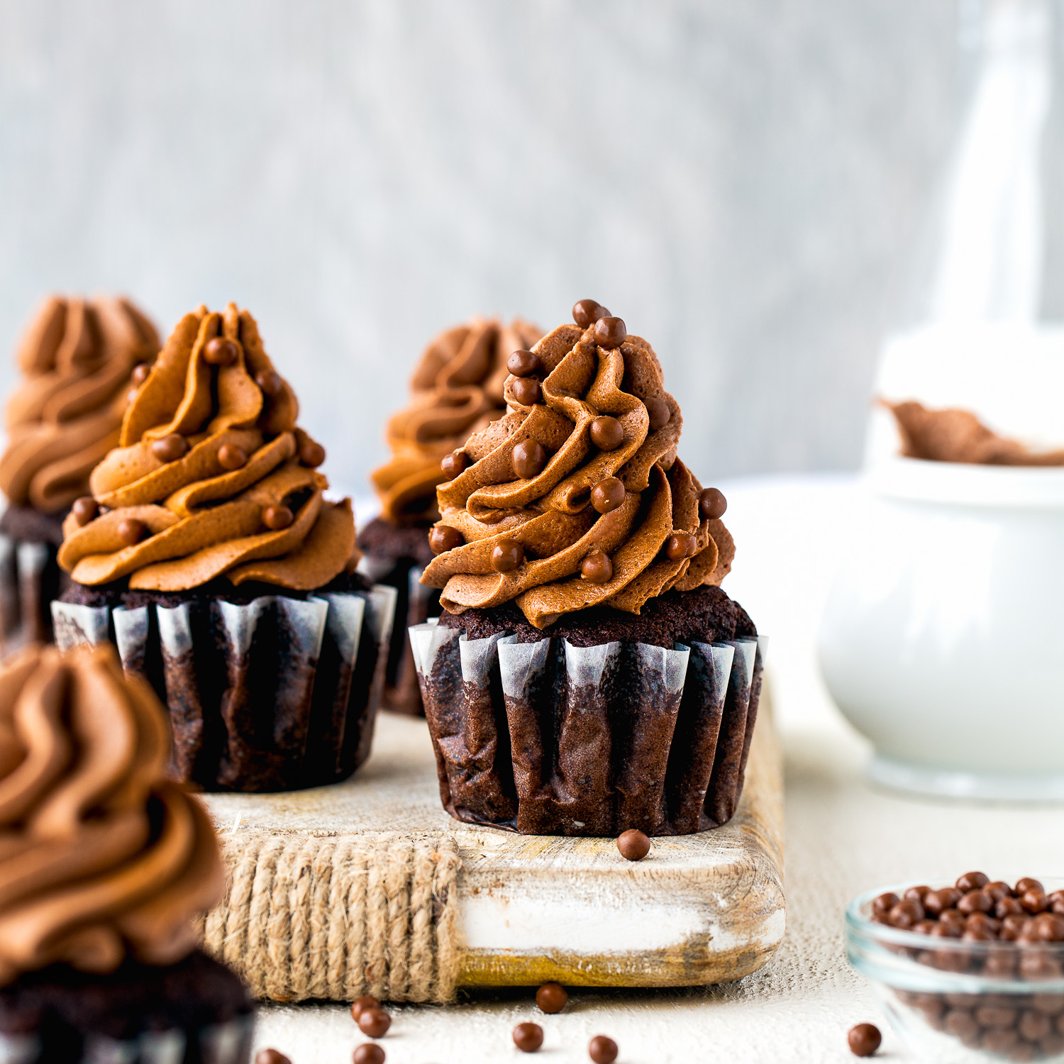 Eggless One Bowl Chocolate Cupcakes with chocolate buttercream and chocolate pearls.