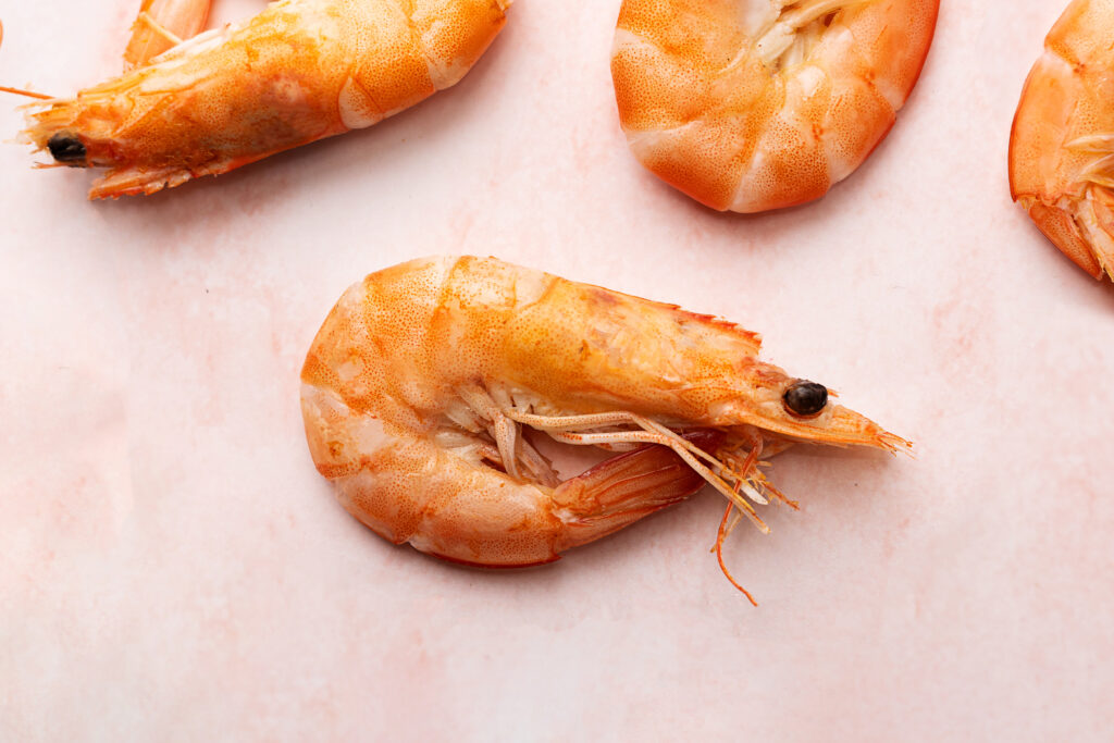 raw shrimp ober a ink surface.